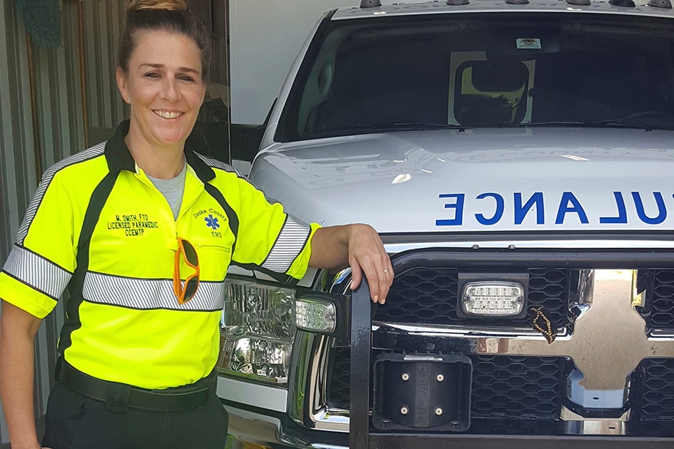 First Responder Leaning on an Ambulance and Smiling