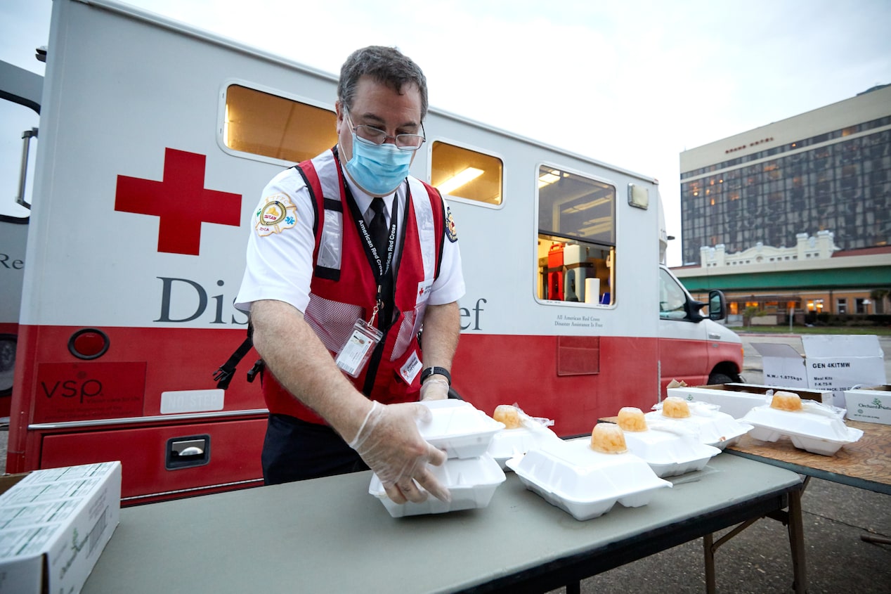 Aid Prepping Crisis Supplies in Front of an Ambulance 