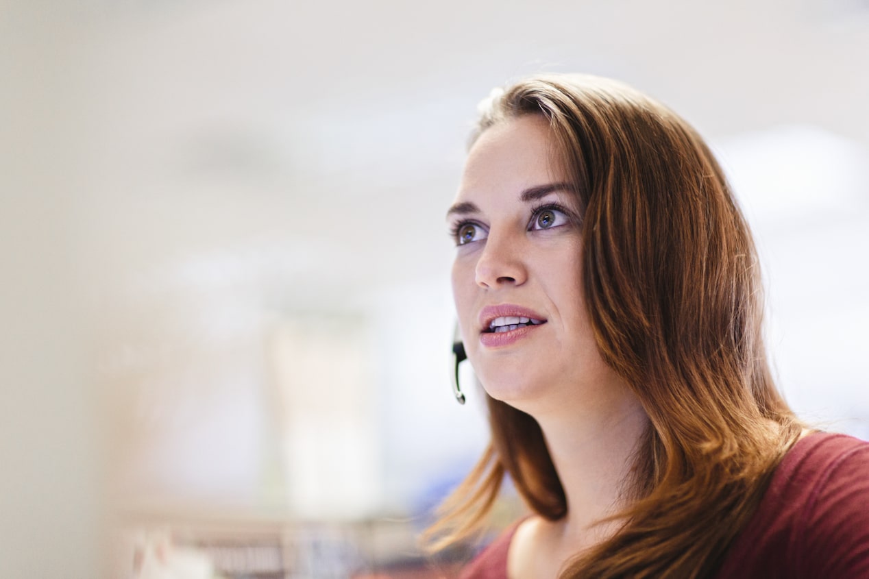 OnStar Advisor Wearing Red Speaks on Headset