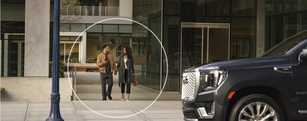 Couple Walking out of Building Towards Their GM Vehicle