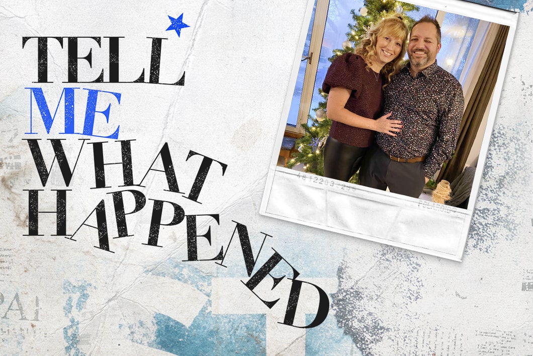 An older couple taking a photo in their house in front of a Christmas tree next to the text overlay of "Tell Me What Happened".