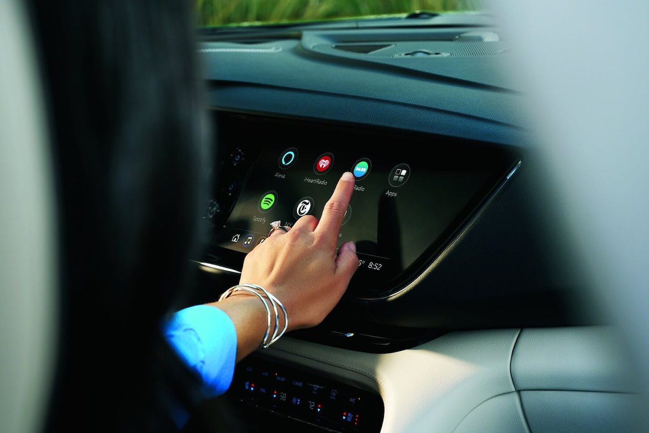 Woman pointing at in-vehicle display apps