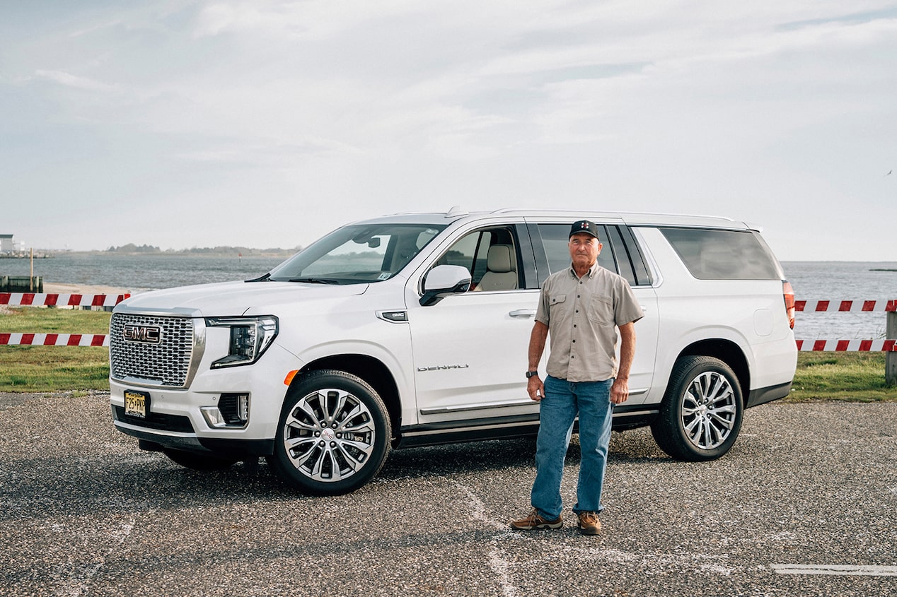 Man Standing in Front of His GMC SUV