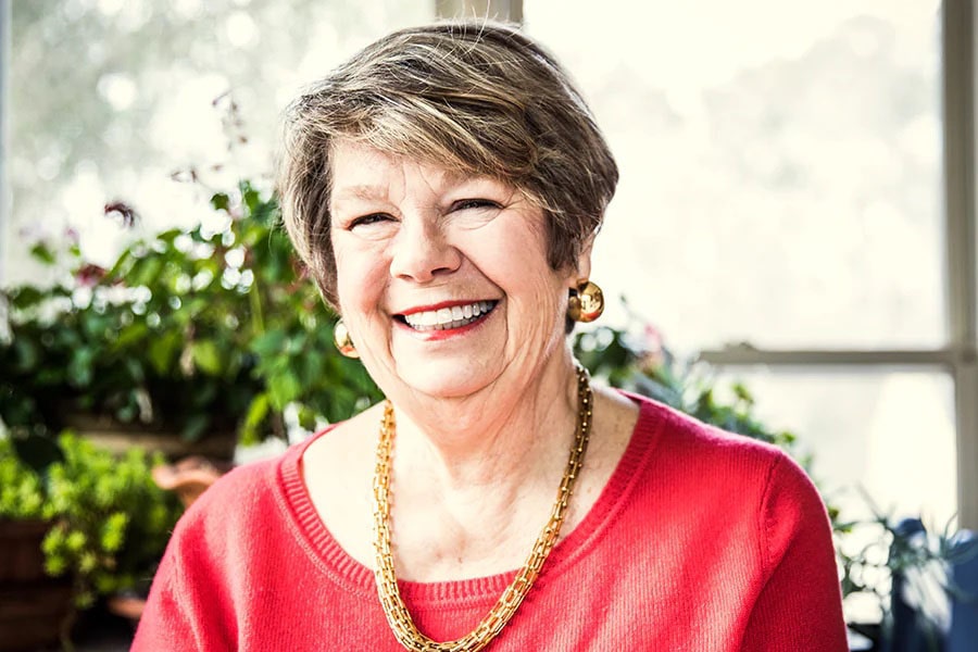 Woman Sitting in a Bright Room Smiling