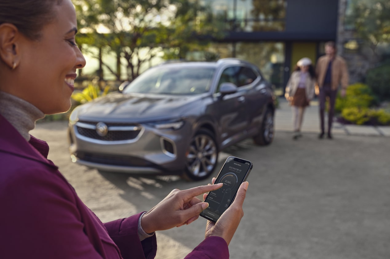 Woman Using her Smartphone with a GM Vehicle in the Background