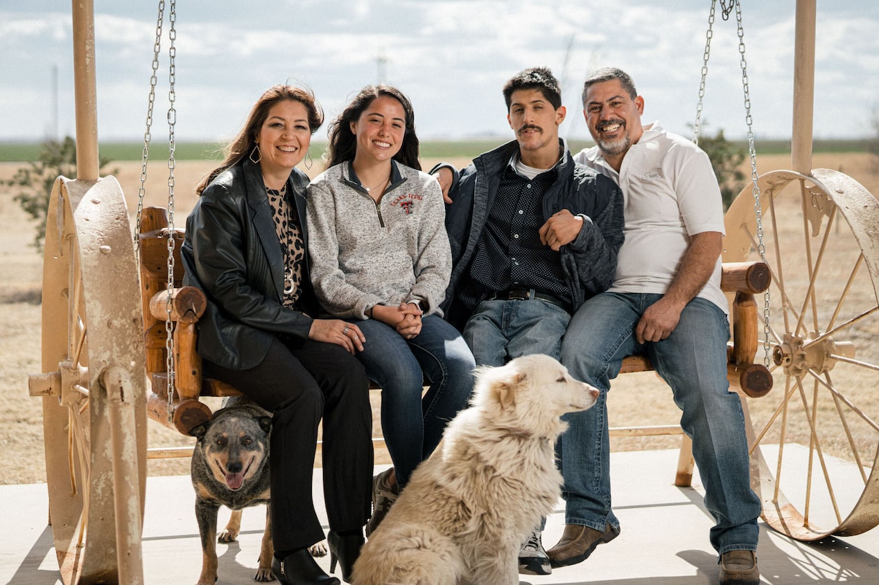 Family of 4 Sitting Outside with Their Dog