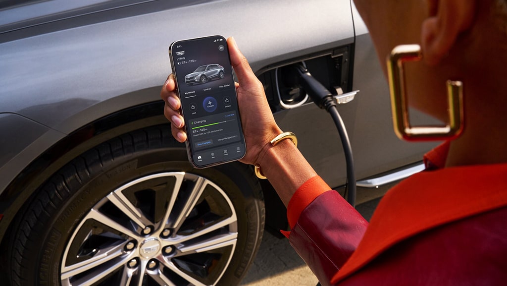 Woman Checking Charge Status of her Cadillac Using myCadillac Mobile App