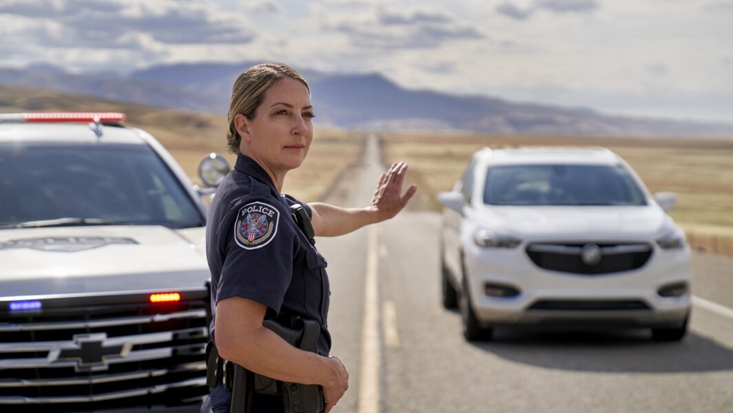 Law Enforcement Officer Stops a GM Vehicle on a Two Lane Road