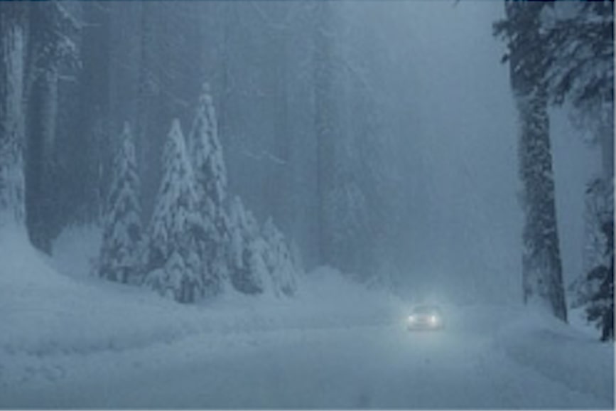 Vehicle Driving Through an Intense Winter Blizzard