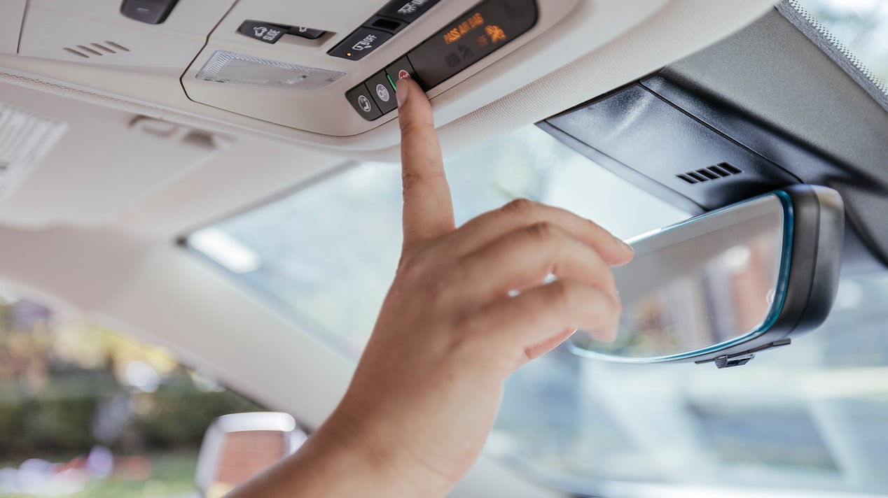 Close up of a Woman Pressing the In Vehicle OnStar Button