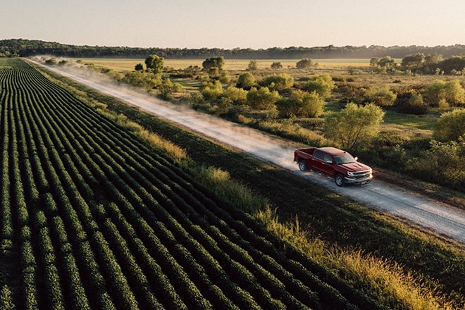 Birds-Eye View of a GM Truck Driving Down an Open Country Road