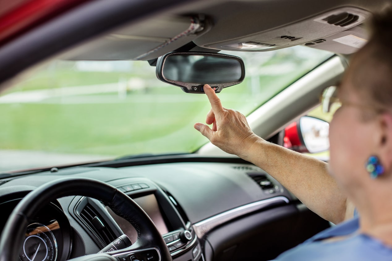 Women Pressing OnStar Button in her Vehicle