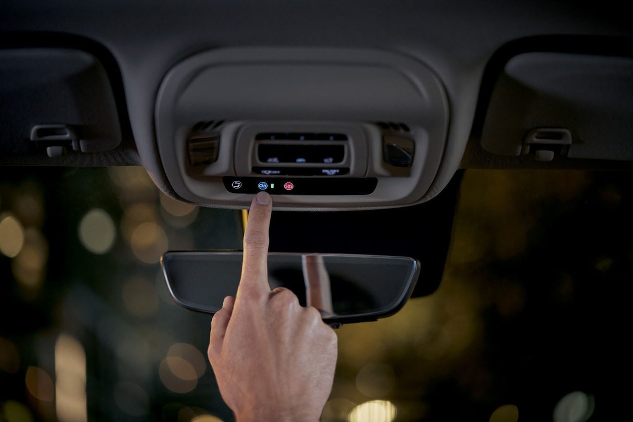 Close up of Driver Pressing the OnStar Button