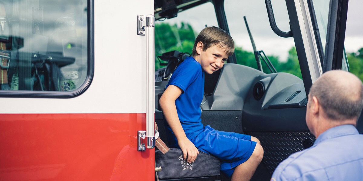 Young Boy Sitting in Passenger Seat of Ambulance