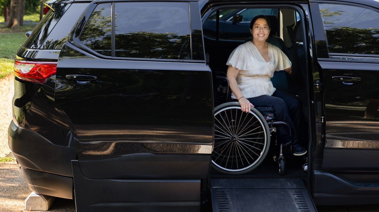 A Woman in a Wheelchair Exiting a Chevy Traverse Using a Ramp