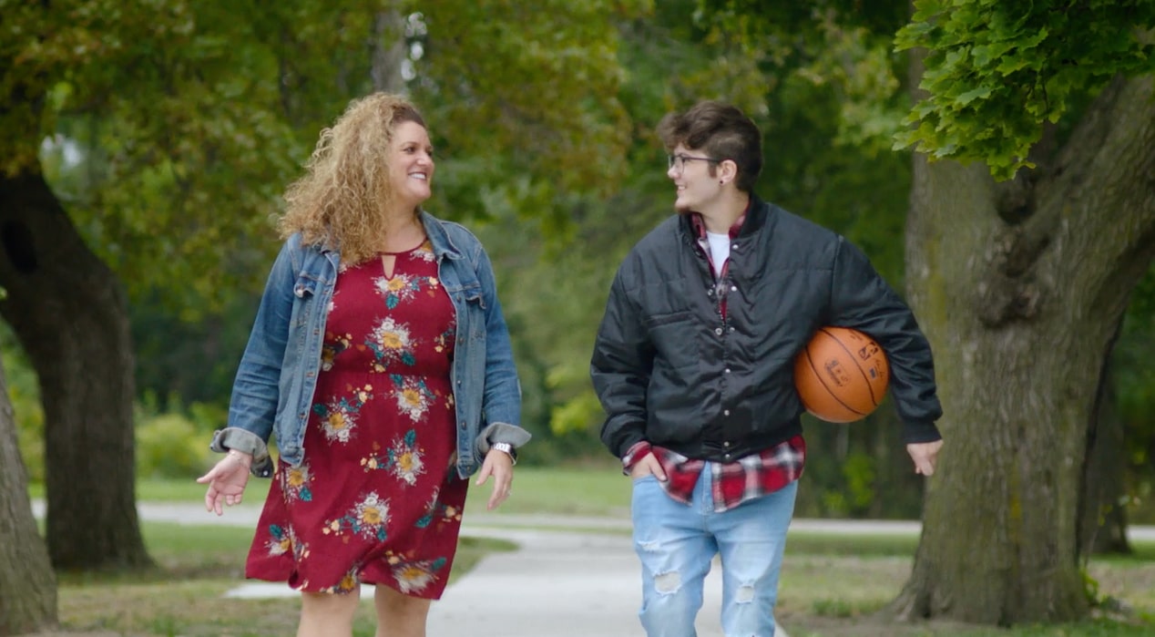 A Man and Woman Walking Together Down a Street