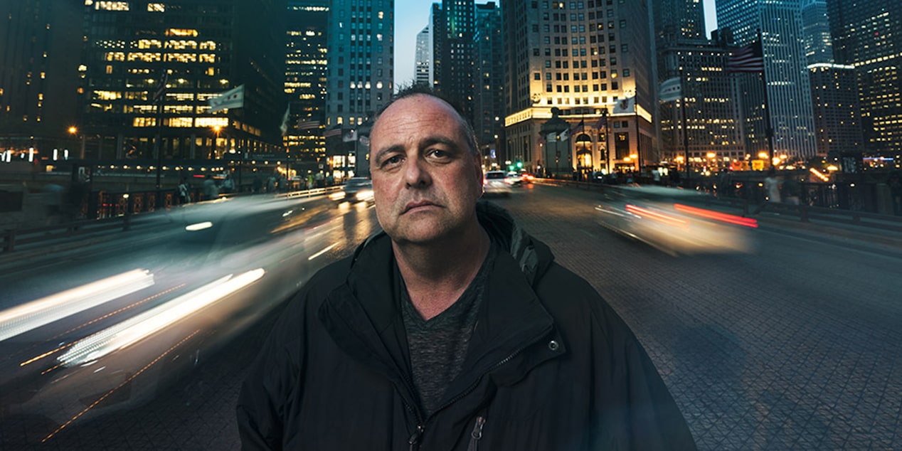 Man Looking at Camera with City View in the Background