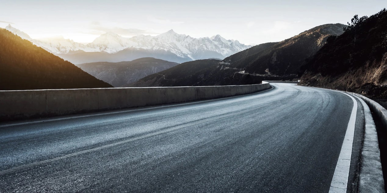 Wide Open Road With Mountains in the Background