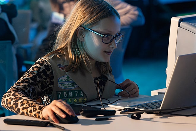 A young Girl Scout using a computer