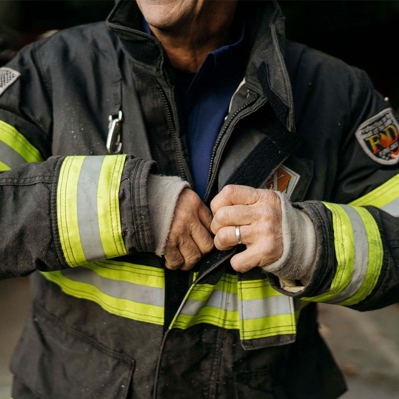 Fire Fighter Adjusting His Fire Suit