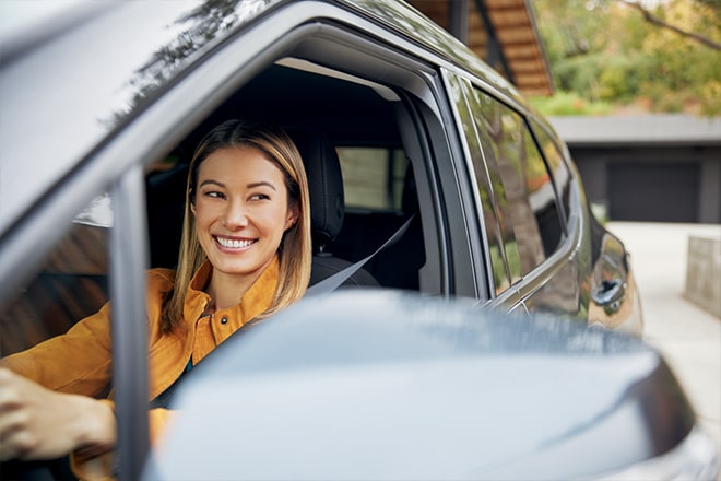 A Woman Smiling While Driving