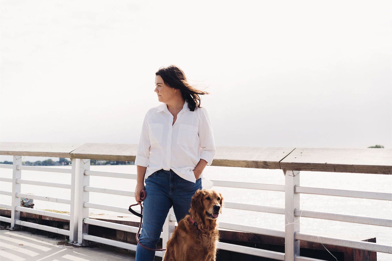 Woman Standing on Peir with her Dog