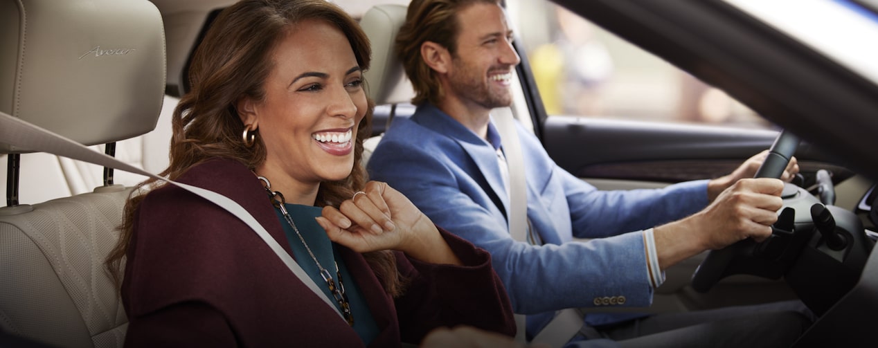 Man and Woman Smiling While Cruising in Their Vehicle