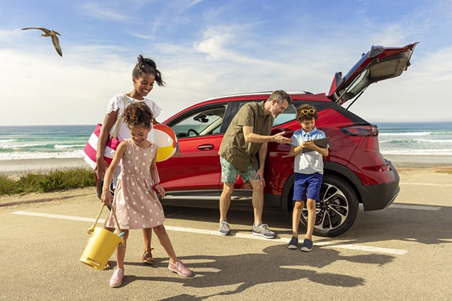 Family Surrounding Vehicle with Trunk Open