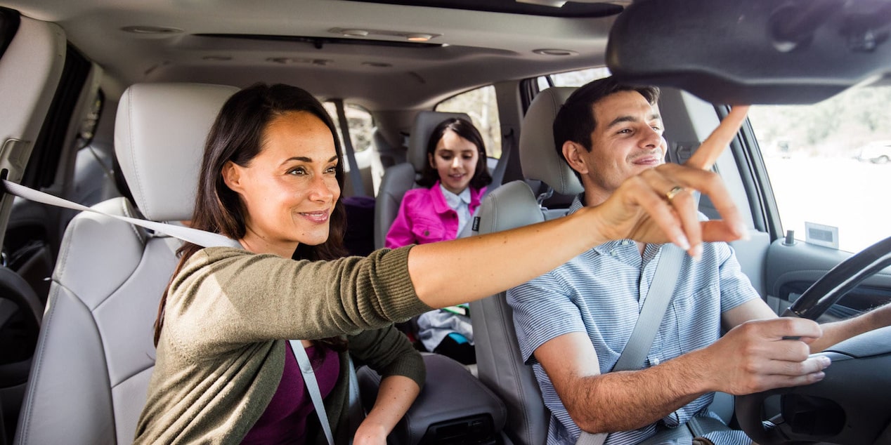 Woman in Passenger Seat Pressing the OnStar Button