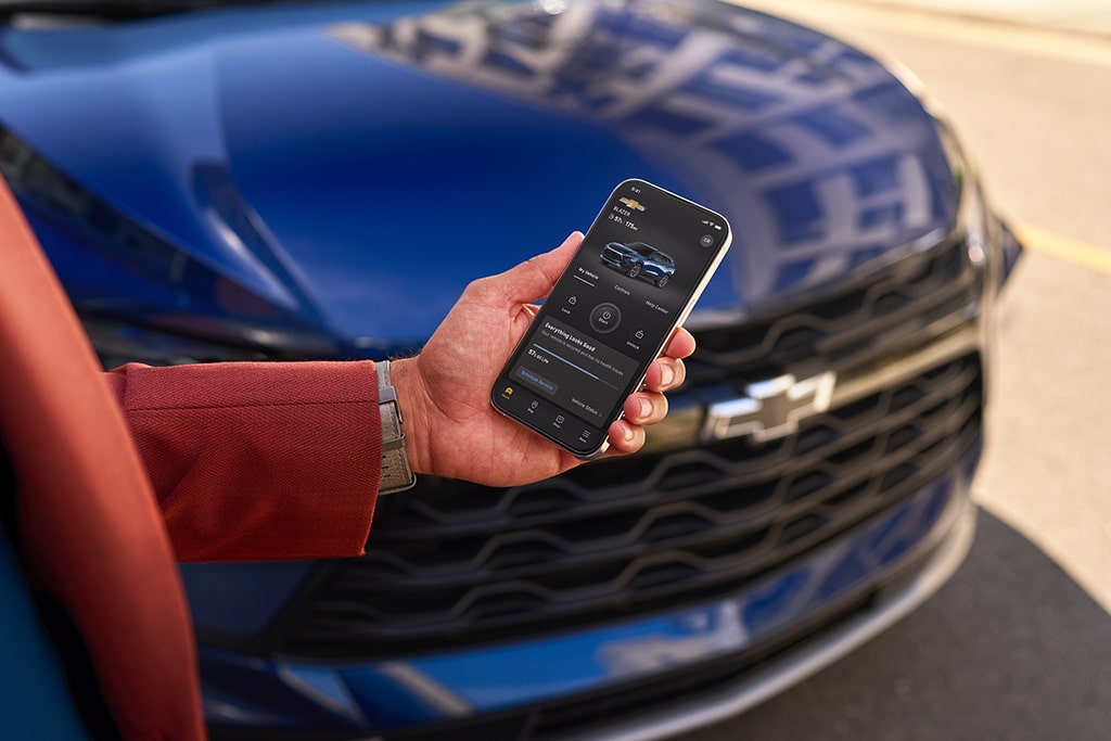 A man using his MyChevrolet mobile app on his smartphone