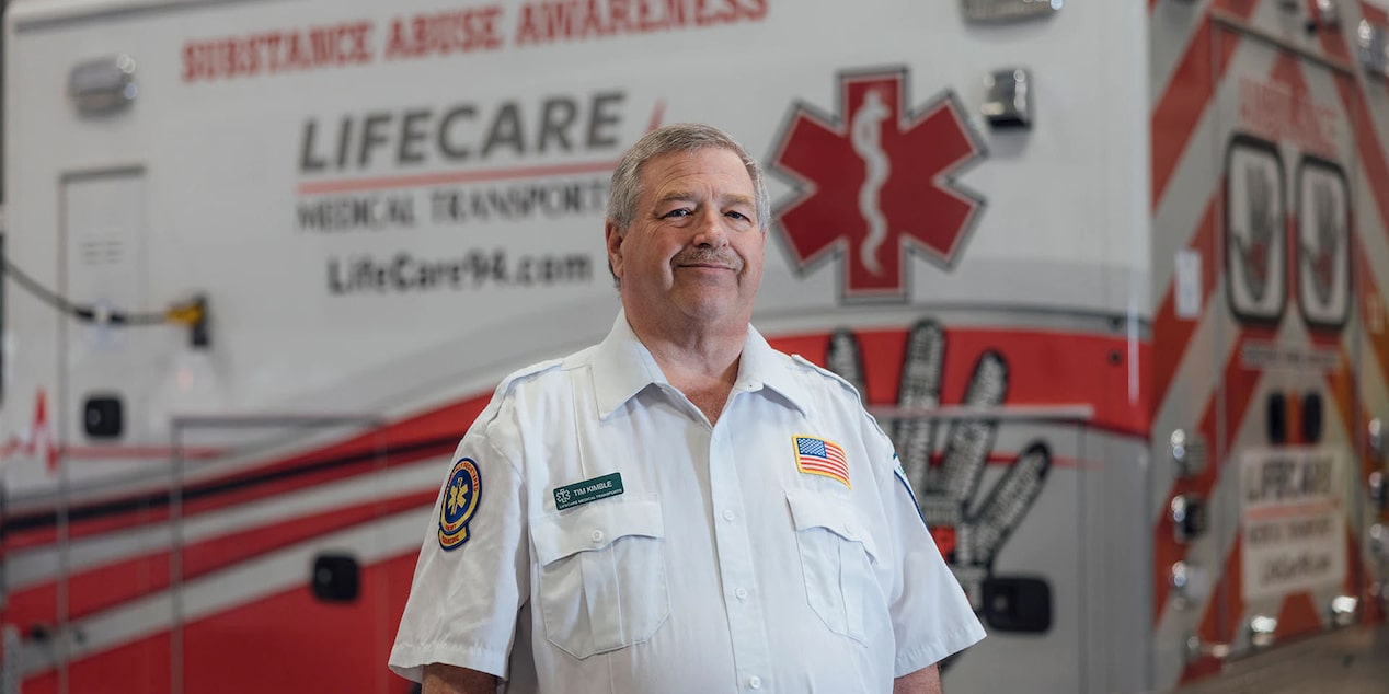 Timothy Kimble First Responder Standing Infront of an Ambulance