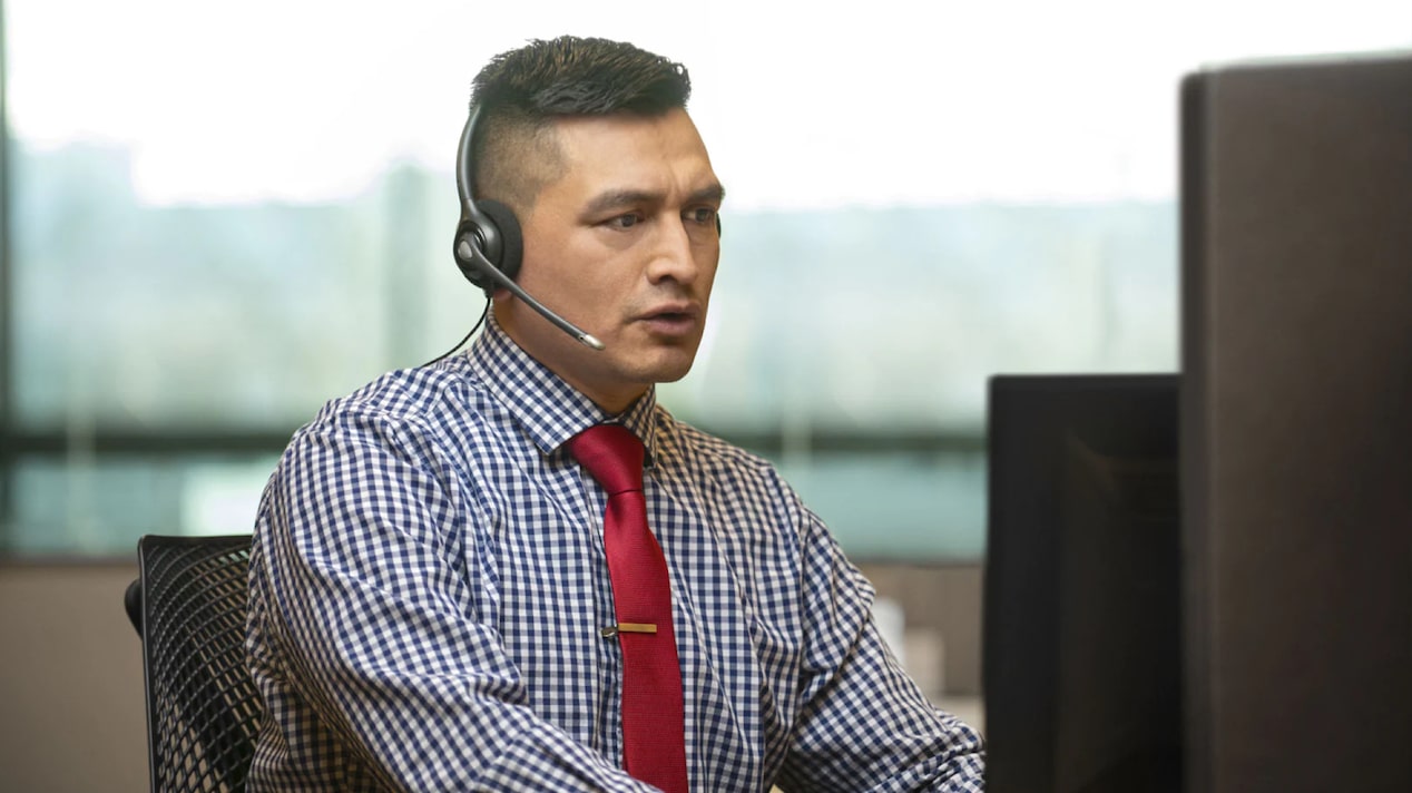 Male OnStar Advisor Wearing Checked Shirt Focused on Helping