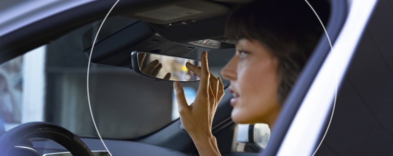 Close-up of Female Driver Pressing the OnStar Button 