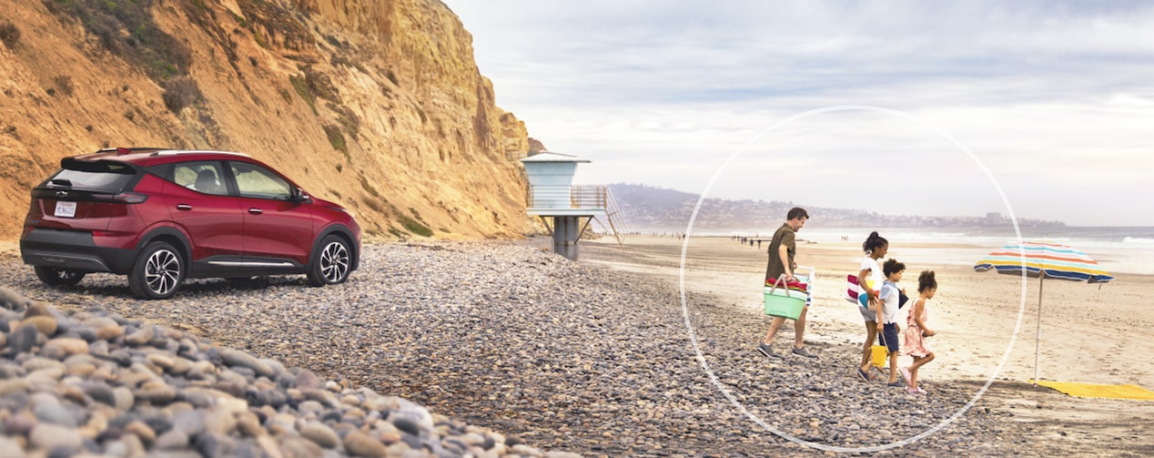 Family at Beach with GM Vehicle in the Background