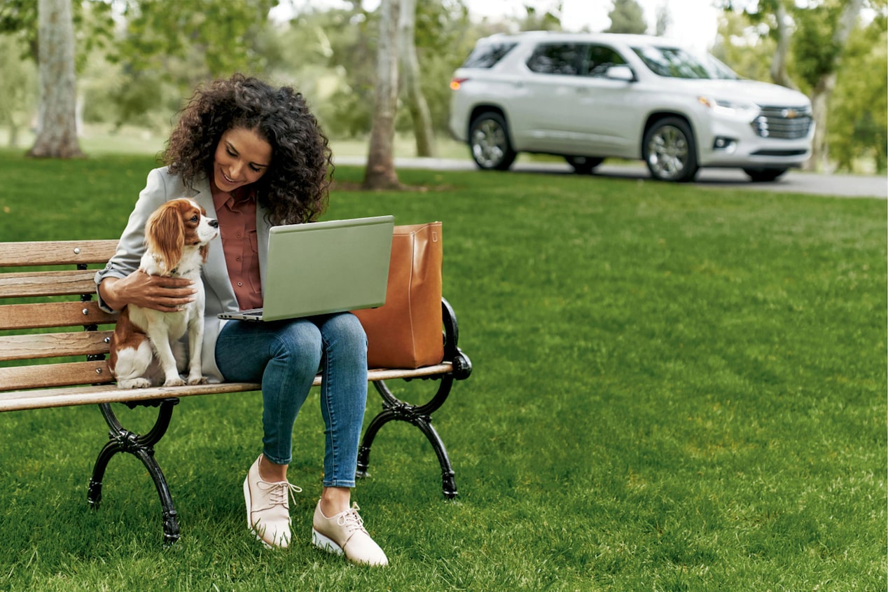 Woman Sitting on Bench with her Dog & Laptop 