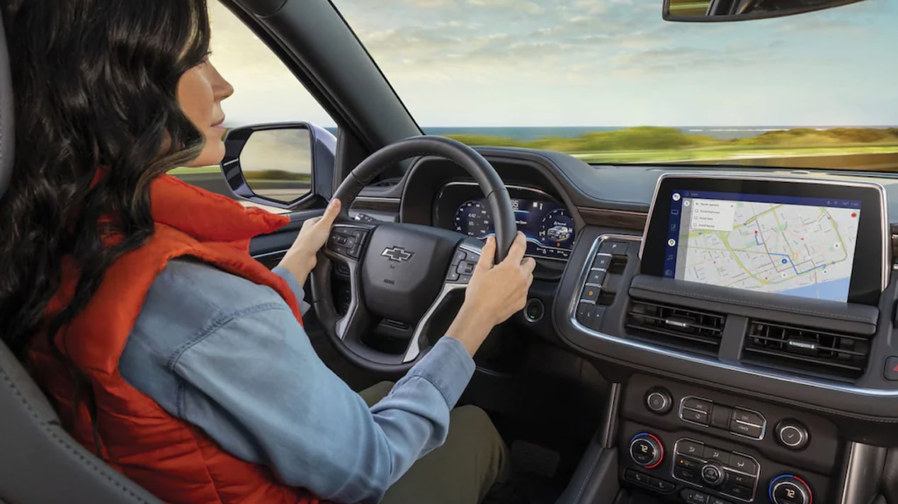 A Woman Uses Her GPS Displayed on her Infotainment System 