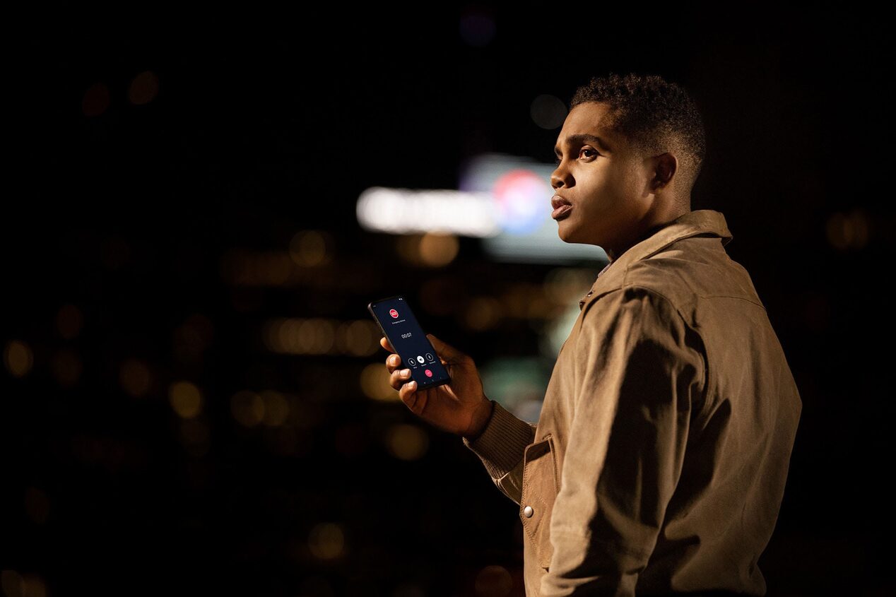 Man Standing Alone at Night on his Phone