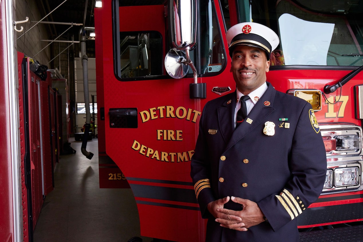 Fire Chief Smiling Standing in front of Fire Truck