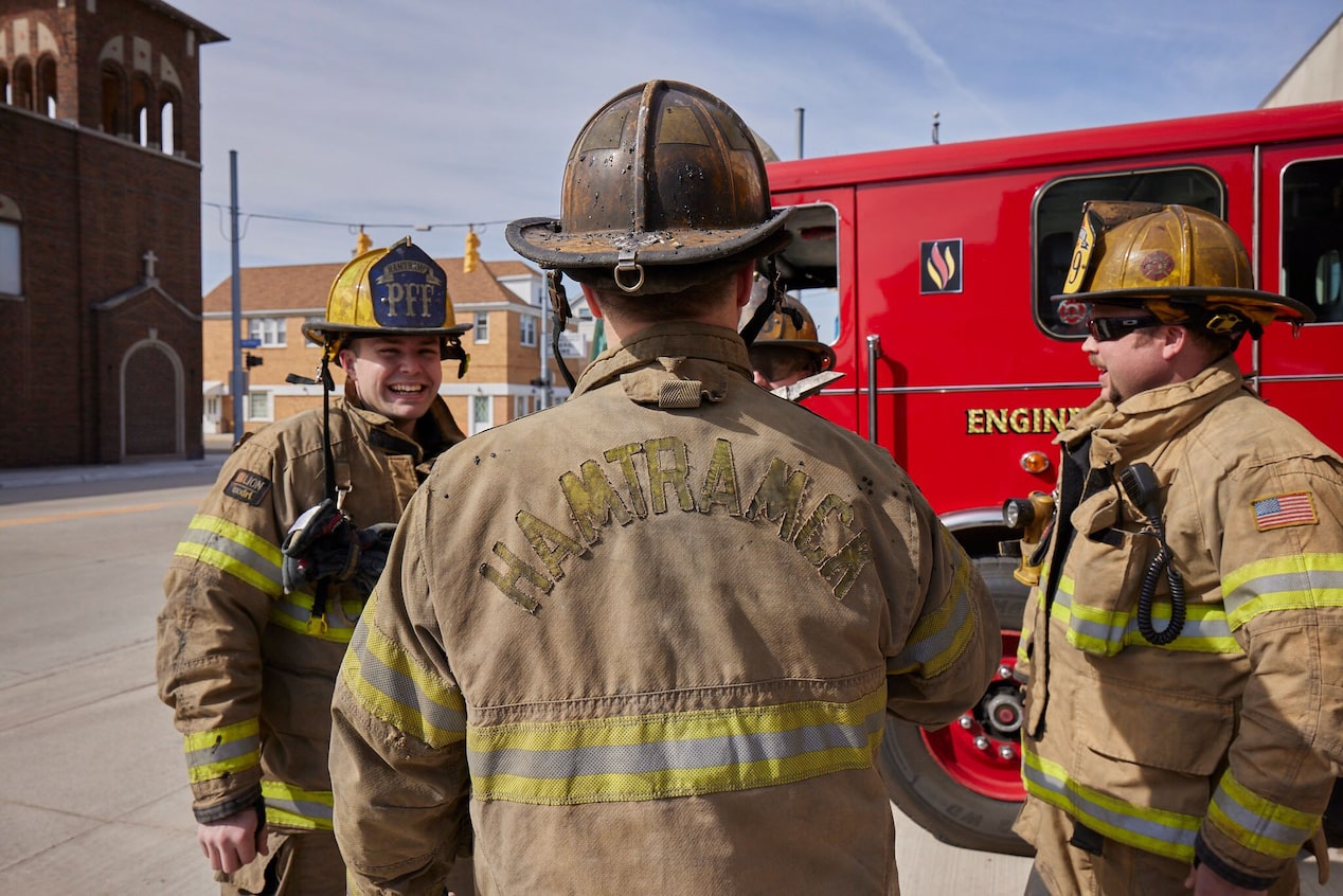 Firefighters Chatting in their Equipment