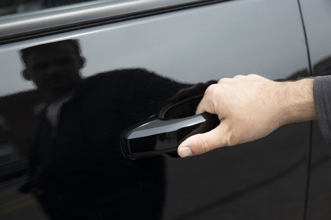 Close Up of a Man Opening a Black Car Door 