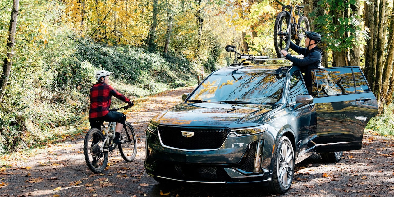 Preparing for a Bike Trip next to Cadillac SUV