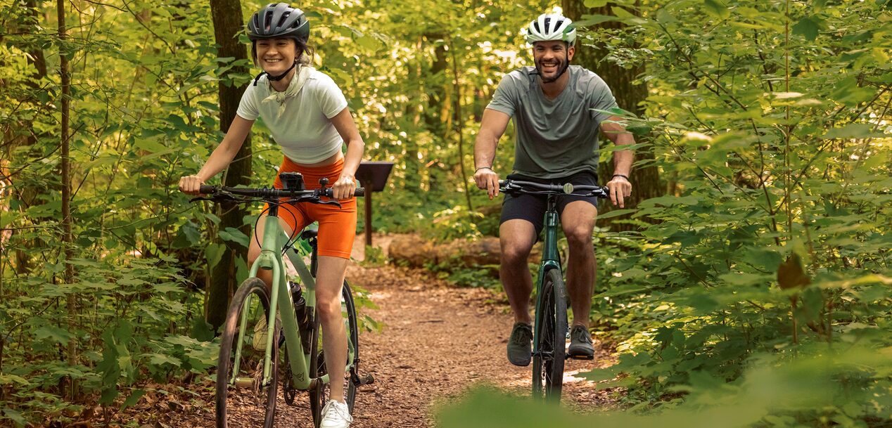 Two Cyclists Enjoying a Ride in the Forest