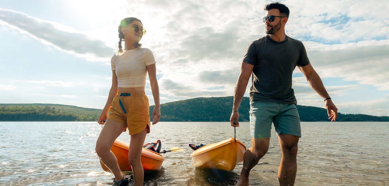 Couple Pulls in Their Kayaks from a Lake