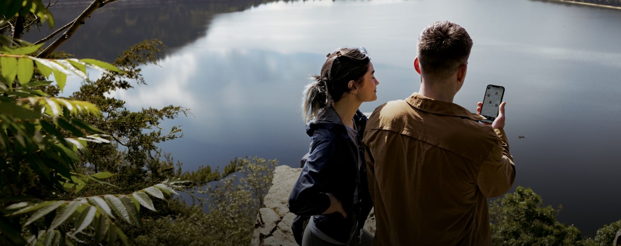 Couple Near Beautiful View While Checking Their Phone