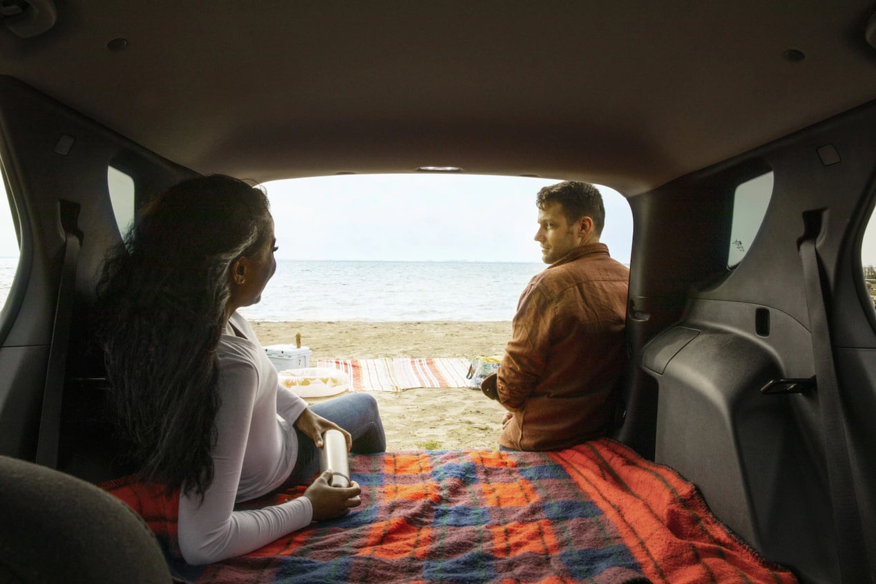 Couple Laying on a Blanket in the back of a GM Vehicle