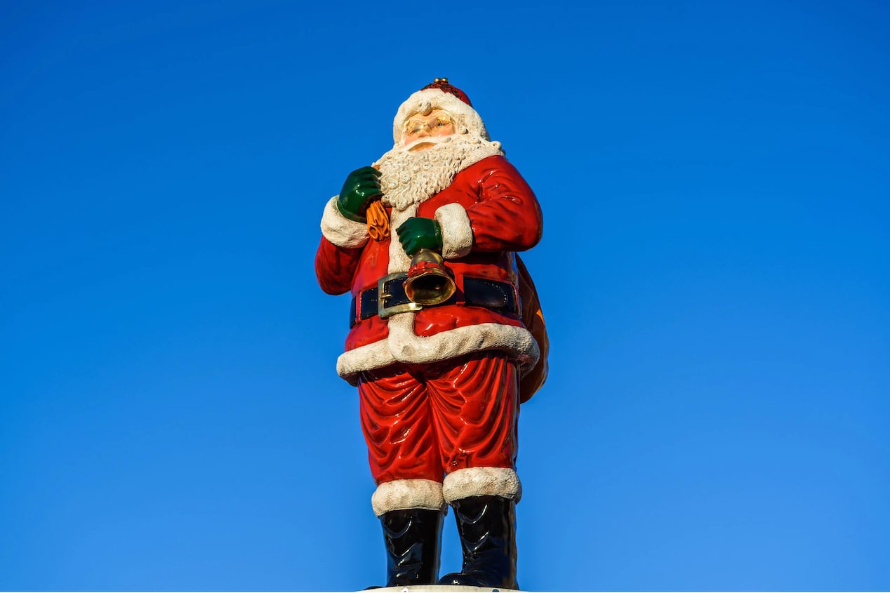 Large Santa Figure Stands With a Clear Blue Sky Background