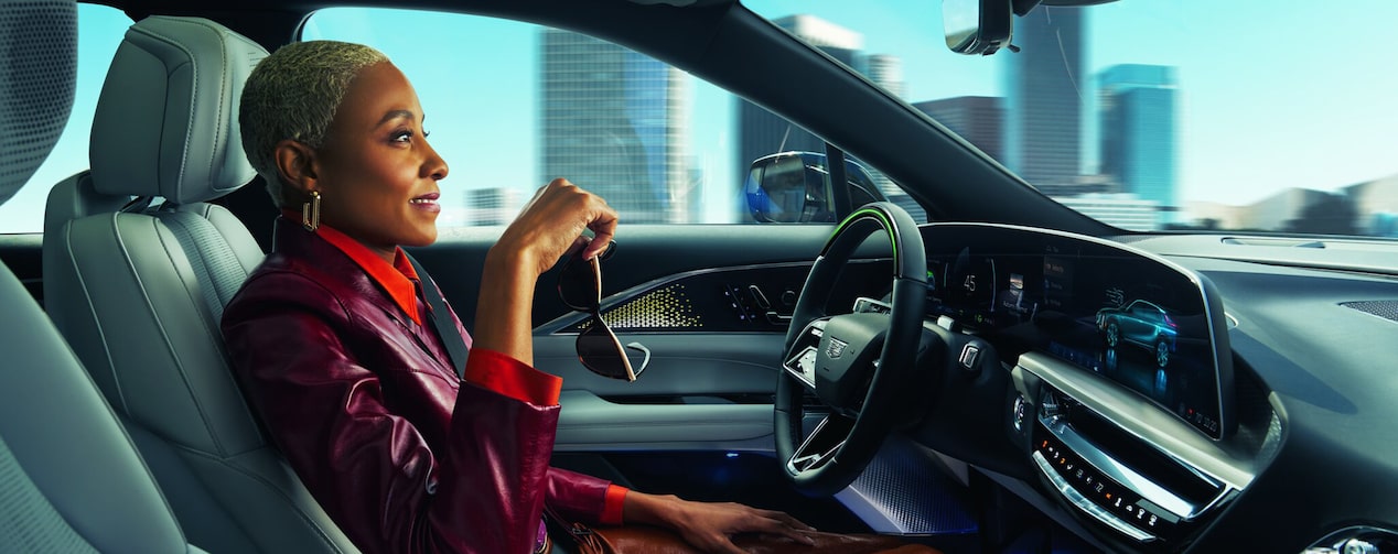 Woman using her in-vehicle voice assistant in her GM vehicle