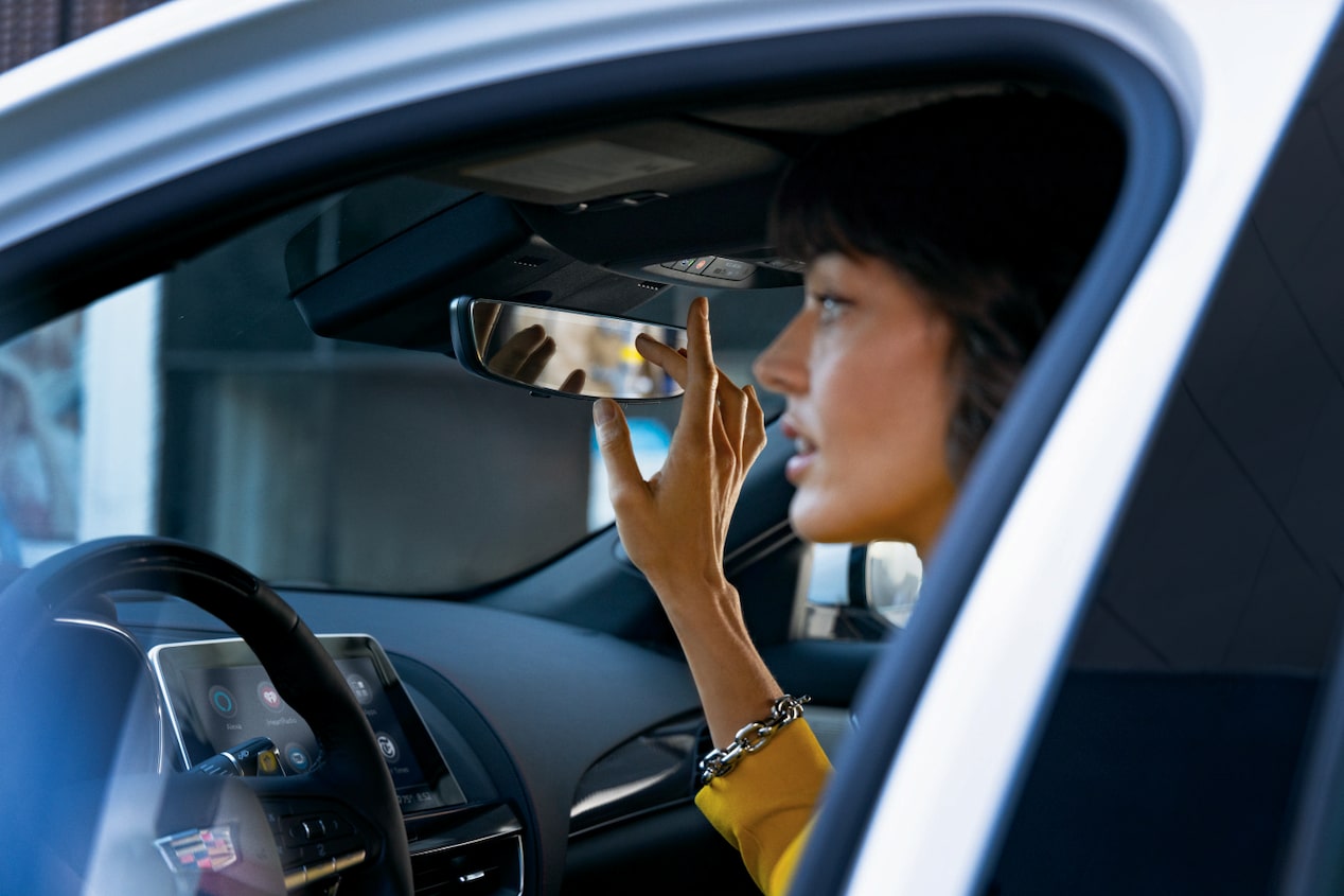 Woman Pressing OnStar IN-Vehicle Button