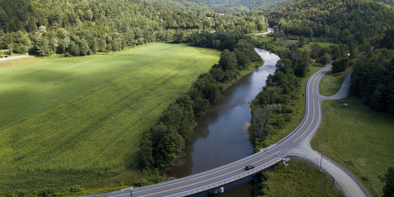 Aerial View of Winding Road Crossing Over a River