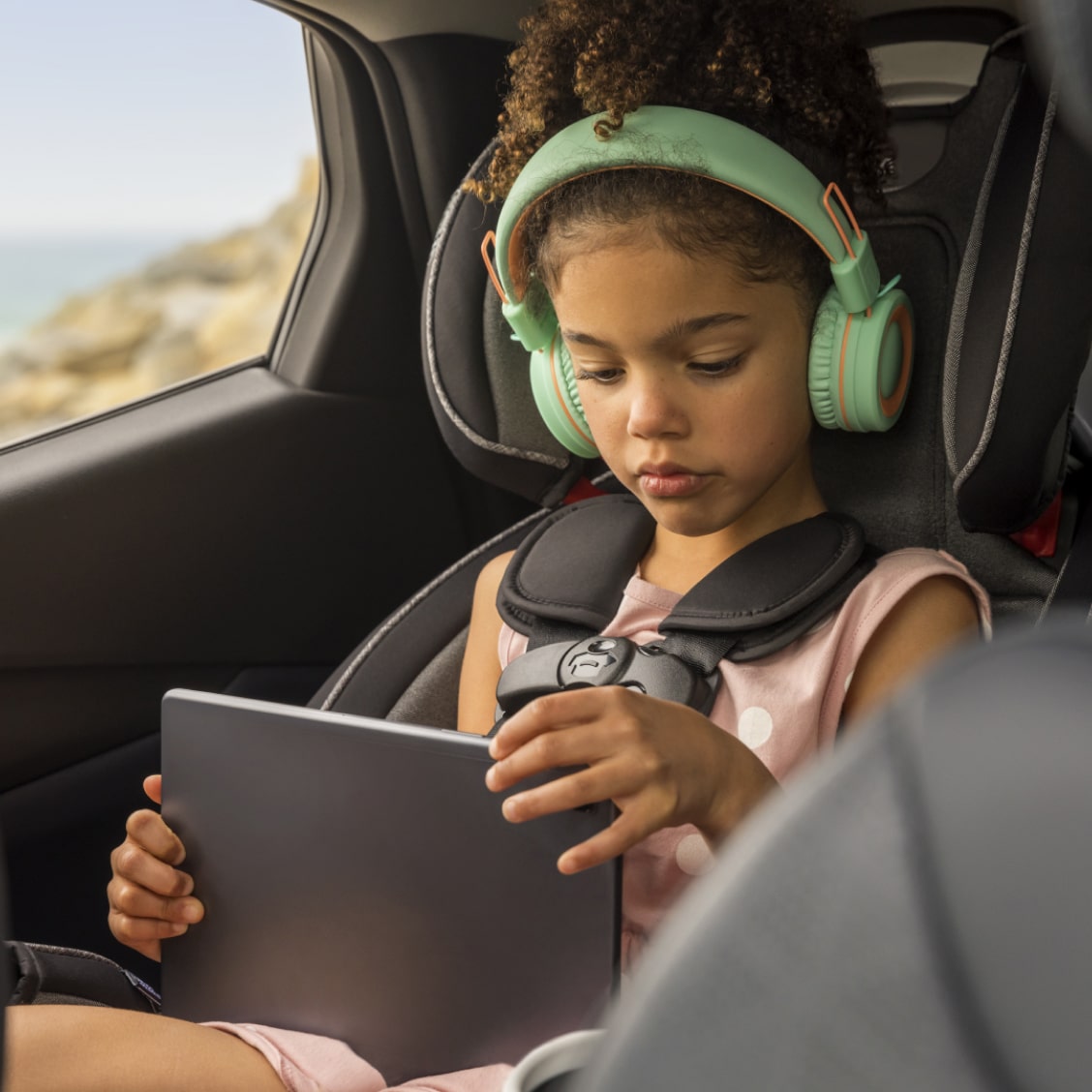 Girl Wearing Headphones Listening to Tablet Device